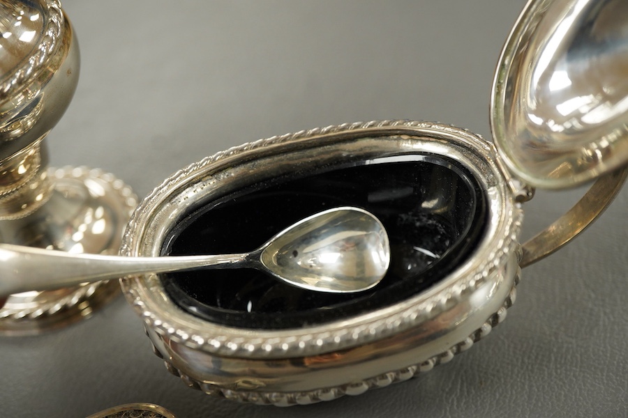 A modern silver pepperette, Birmingham, 1988, 14cm, a silver mustard pot and associated silver spoon, a silver mounted notecase and a filigree white metal card case.